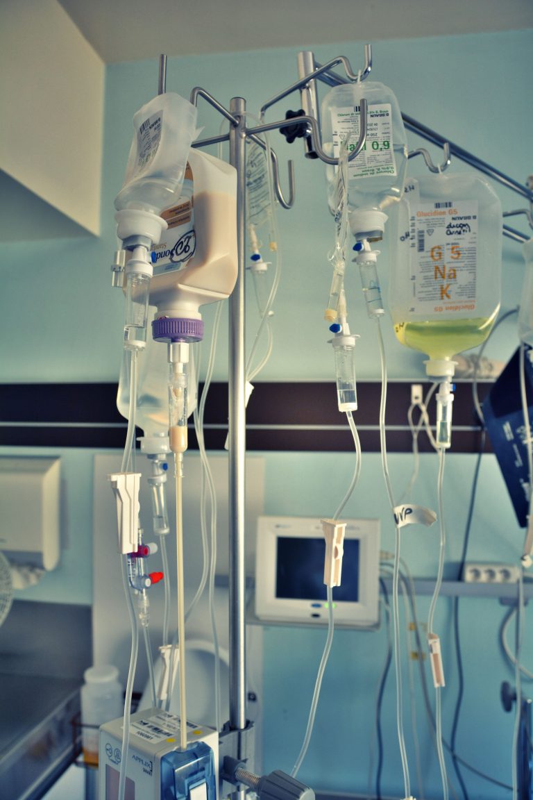 Vertical shot of a medical facility with IV drips and monitors, capturing a clinical healthcare environment.