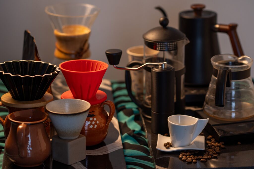 Explore an array of coffee brewing tools including drippers, grinders, and cups, ideal for crafting specialty coffee at home.